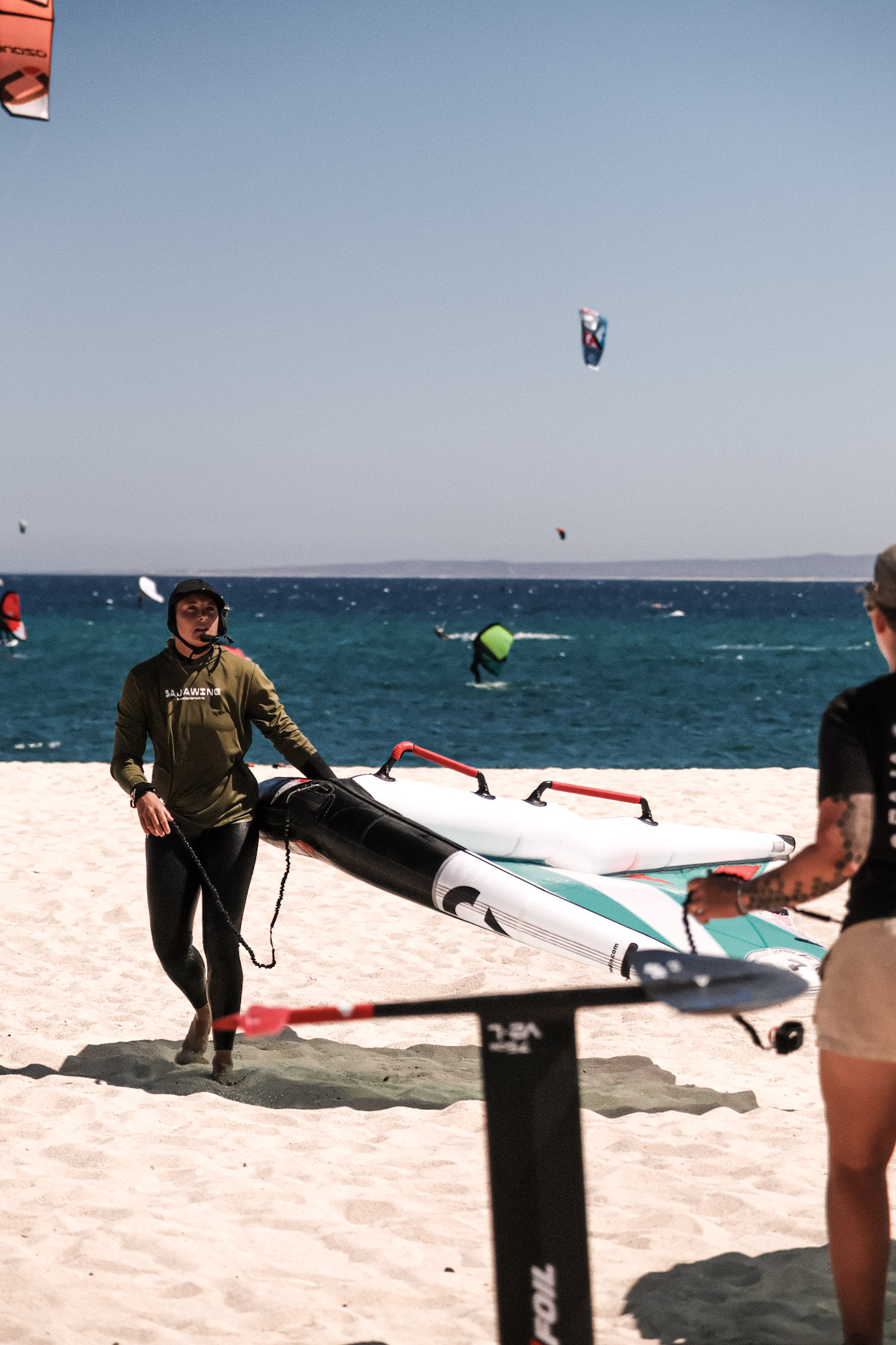 Preparing wingfoil equipment on the sand
