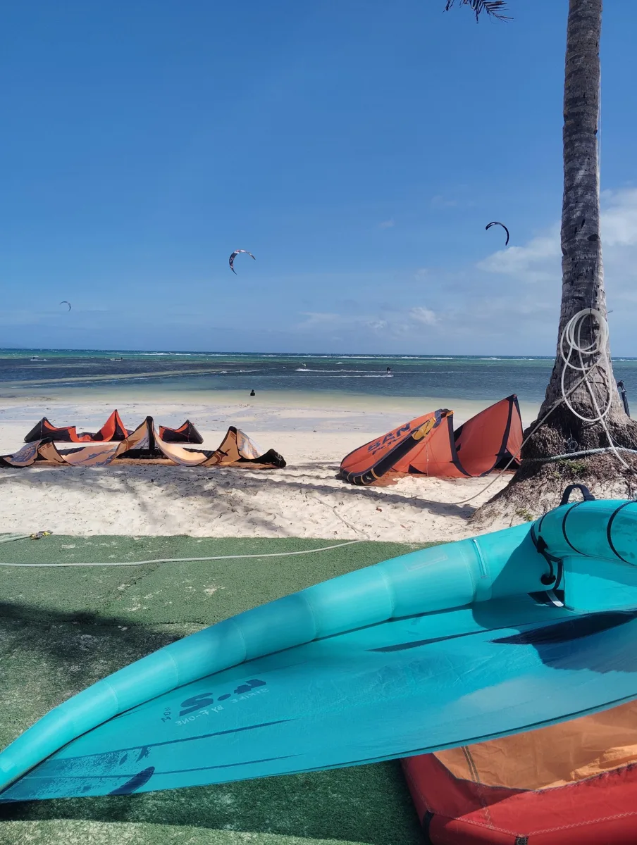 Turquoise kayak and watersports equipment on a palm-lined Boracay beach