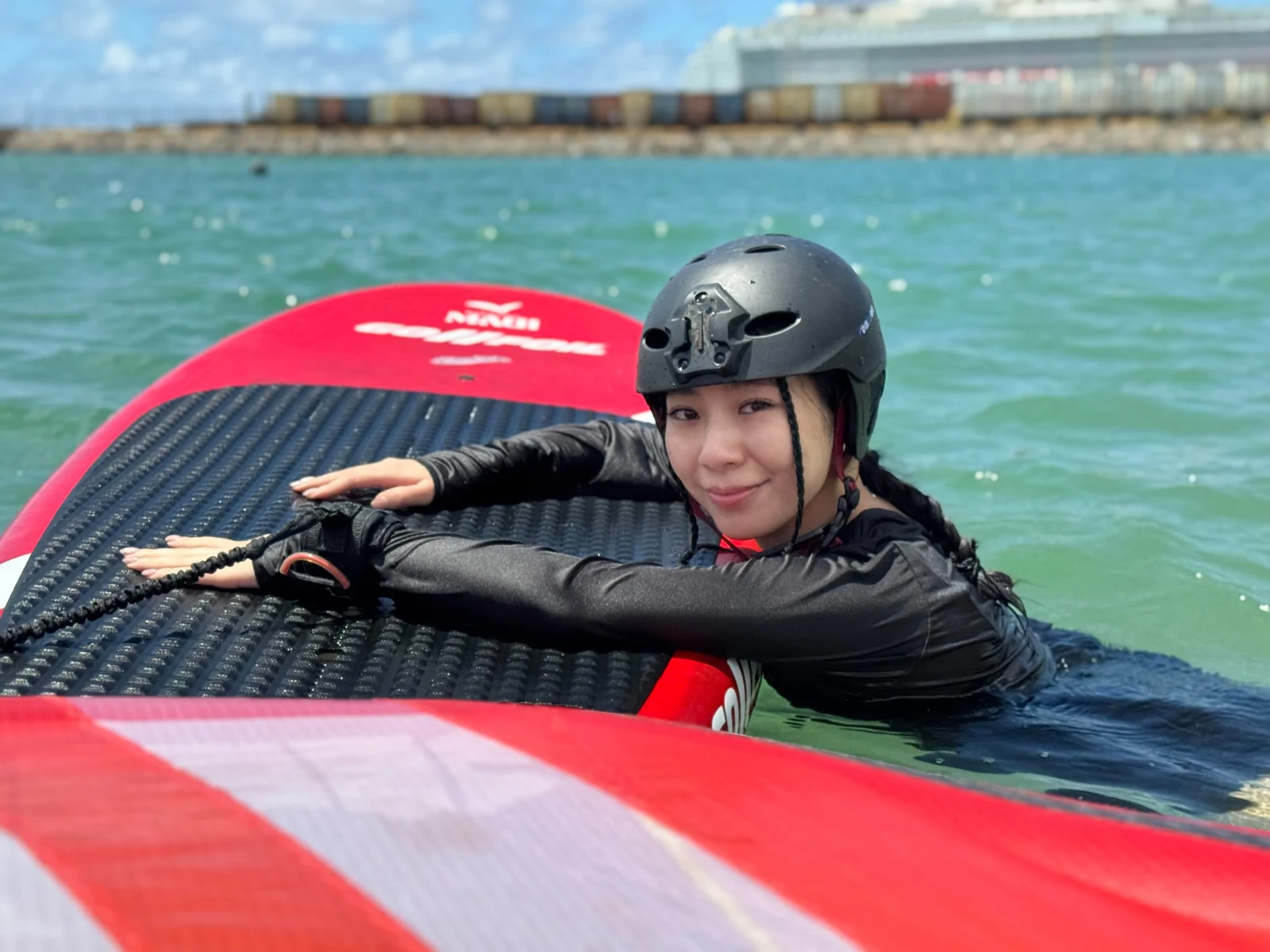 Student resting beside a red wing during a water session
